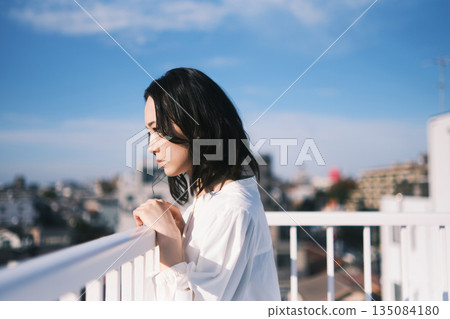 Young woman looking outside on the rooftop 135084180