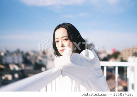 Young woman looking outside on the rooftop 135084183