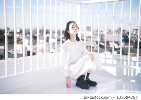 Rooftop portrait of a young woman 135084267