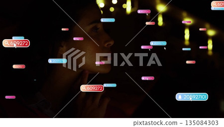 Looking at colorful digital image, person in dark environment focusing intently Looking at colorful digital image, person in dark environment focusing intently 135084303