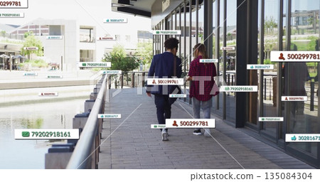 Walking on sidewalk, people surrounded by floating digital data tags in image Walking on sidewalk, people surrounded by floating digital data tags in image 135084304