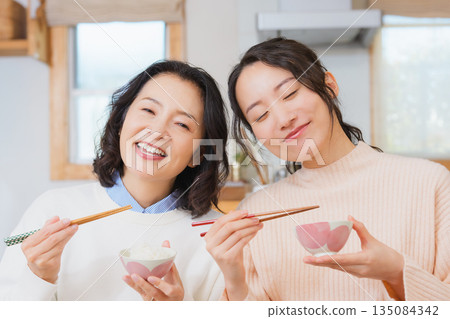 Mother and daughter smiling and saying it's delicious 135084342