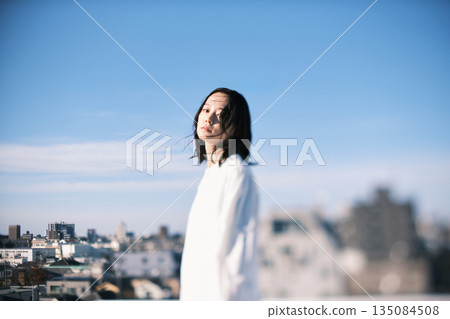 Young woman standing on the roof Young woman standing on the roof 135084508
