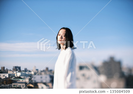 Young woman standing on the roof Young woman standing on the roof 135084509