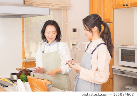 Daughter learning cooking from mother 135084608