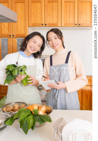 Daughter learning cooking from mother 135084647