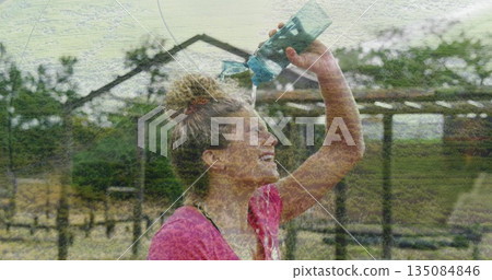 Pouring water over scalp, woman in pink sports top by rural pergola with turquoise bottle Pouring water over scalp, woman in pink sports top by rural pergola with turquoise bottle 135084846