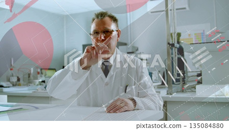 Pointing scientist wearing lab coat raising finger at digital display in lab, showing data overlays 135084880