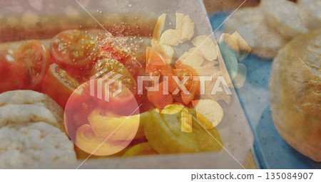 Presenting tray holding tomato halves, chips at deli, with rice crackers, rolls on blue surface 135084907