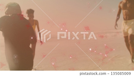 Walking family wearing shorts, one-piece and trunks on shoreline, with water and pink sparkles Walking family wearing shorts, one-piece and trunks on shoreline, with water and pink sparkles 135085009