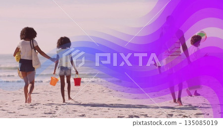 Walking family carrying plastic buckets on beach at low tide, with inflatable ball and striped tote Walking family carrying plastic buckets on beach at low tide, with inflatable ball and striped tote 135085019