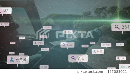 Observing Indian driver leaning on window in car by riverbank with data overlays, copy space 135085021