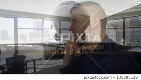 Talking traveler in dark-collared shirt using telephone handset inside airport lounge with jet Talking traveler in dark-collared shirt using telephone handset inside airport lounge with jet 135085129