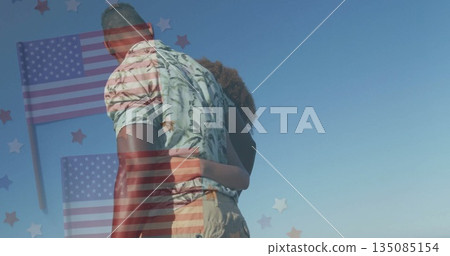Standing embracing couple wearing leaf-print shirt casual wear outdoors, with flag-star graphics Standing embracing couple wearing leaf-print shirt casual wear outdoors, with flag-star graphics 135085154