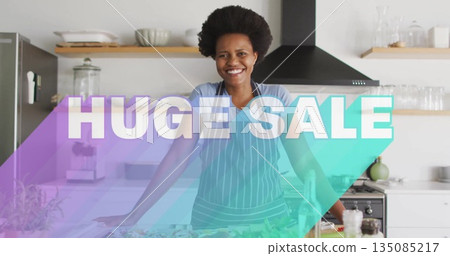 Smiling woman wearing striped apron leaning on kitchen island, with fresh produce and blender Smiling woman wearing striped apron leaning on kitchen island, with fresh produce and blender 135085217