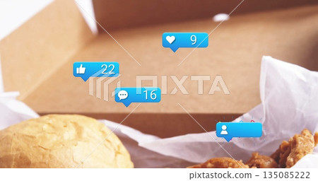 Displaying sandwich bun and fried chicken in takeout box, with notification icons Displaying sandwich bun and fried chicken in takeout box, with notification icons 135085222