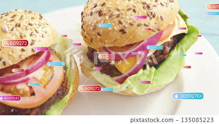 Displaying two cheeseburgers resting on ceramic plate on blue tabletop, with digital numeric tags Displaying two cheeseburgers resting on ceramic plate on blue tabletop, with digital numeric tags 135085223