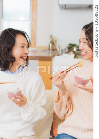 Mother and daughter smiling and saying it's delicious 135085522