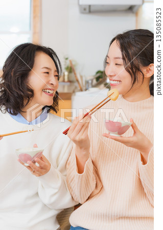 Mother and daughter smiling and saying it's delicious 135085523