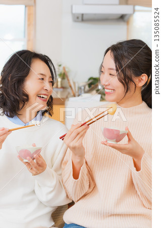 Mother and daughter smiling and saying it's delicious 135085524