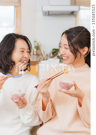 Mother and daughter smiling and saying it's delicious 135085525