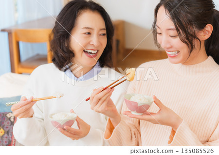 Mother and daughter smiling and saying it's delicious 135085526