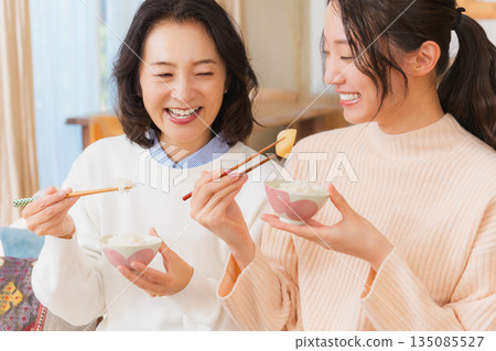 Mother and daughter smiling and saying it's delicious 135085527