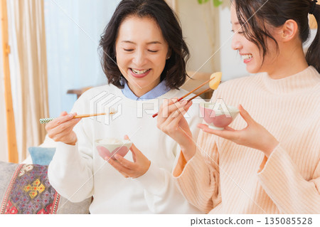 Mother and daughter smiling and saying it's delicious 135085528