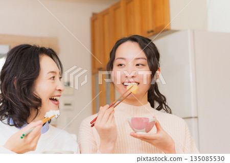 Mother and daughter smiling and saying it's delicious 135085530