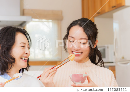 Mother and daughter smiling and saying it's delicious 135085531