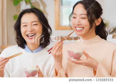 Mother and daughter smiling and saying it's delicious 135085533