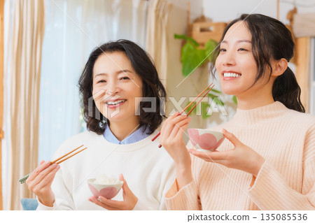 Mother and daughter smiling and saying it's delicious Mother and daughter smiling and saying it's delicious 135085536