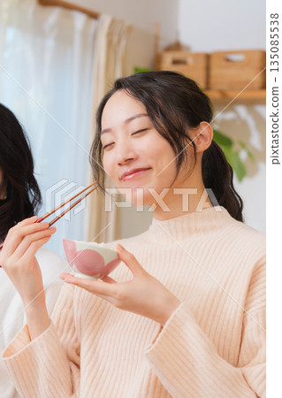 Mother and daughter smiling and saying it's delicious 135085538