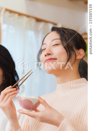 Mother and daughter smiling and saying it's delicious 135085539