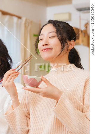 Mother and daughter smiling and saying it's delicious 135085540