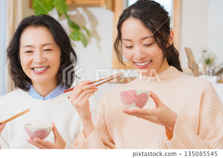 Mother and daughter smiling and saying it's delicious 135085545