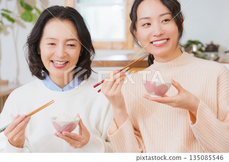 Mother and daughter smiling and saying it's delicious 135085546