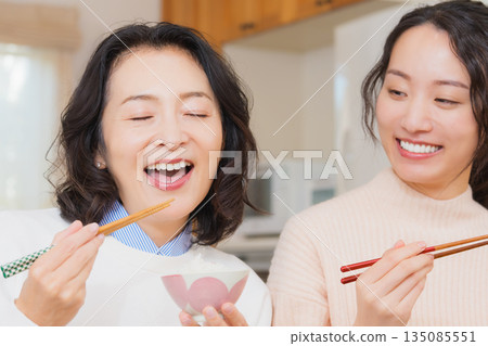 Mother and daughter smiling and saying it's delicious Mother and daughter smiling and saying it's delicious 135085551