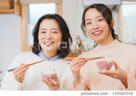 Mother and daughter smiling and saying it's delicious 135085558