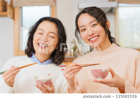 Mother and daughter smiling and saying it's delicious 135085559