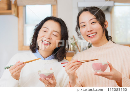 Mother and daughter smiling and saying it's delicious 135085560