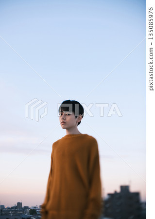 Portrait of a man on a rooftop at dusk 135085976