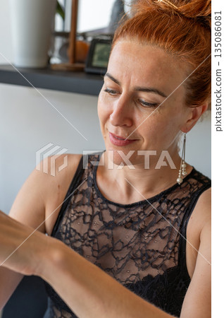 Portrait of a smiling woman - Group of friends have fun together at outdoor restaurant bar on a summer evening toasting and drinking red wine in glasses - Happy young people take a break. High quality 135086081