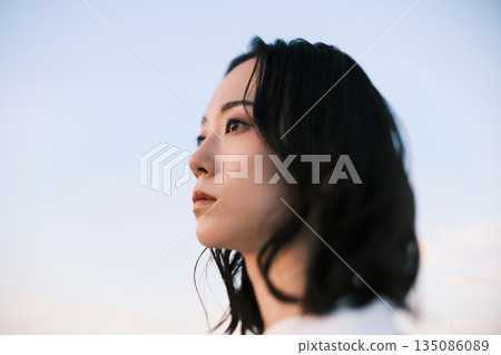 Sunset portrait of a young woman Sunset portrait of a young woman 135086089