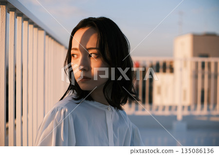 Portrait of a woman on a rooftop at dusk Portrait of a woman on a rooftop at dusk 135086136