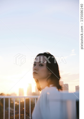 Portrait of a woman on a rooftop at dusk Portrait of a woman on a rooftop at dusk 135086140