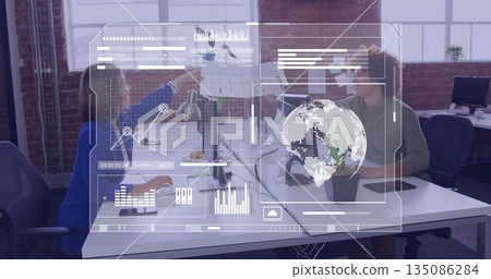 Pointing colleagues showing data trends in modern office, with printed chart, holographic overlays 135086284