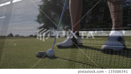 Standing golfer's legs preparing stroke on putting green, with putter, ball and encryption code Standing golfer's legs preparing stroke on putting green, with putter, ball and encryption code 135086341
