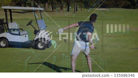 Swinging adult male golfer taking backswing on golf fairway, with golf club, cart and HUD graphics 135086346