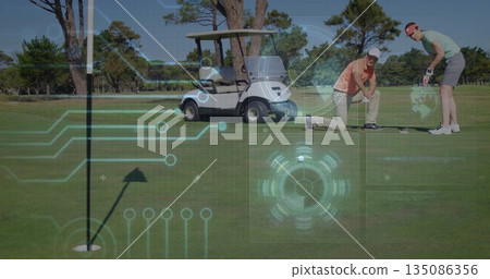 Putting golfers wearing polos making putts on green with golf cart and digital overlays, copy space 135086356